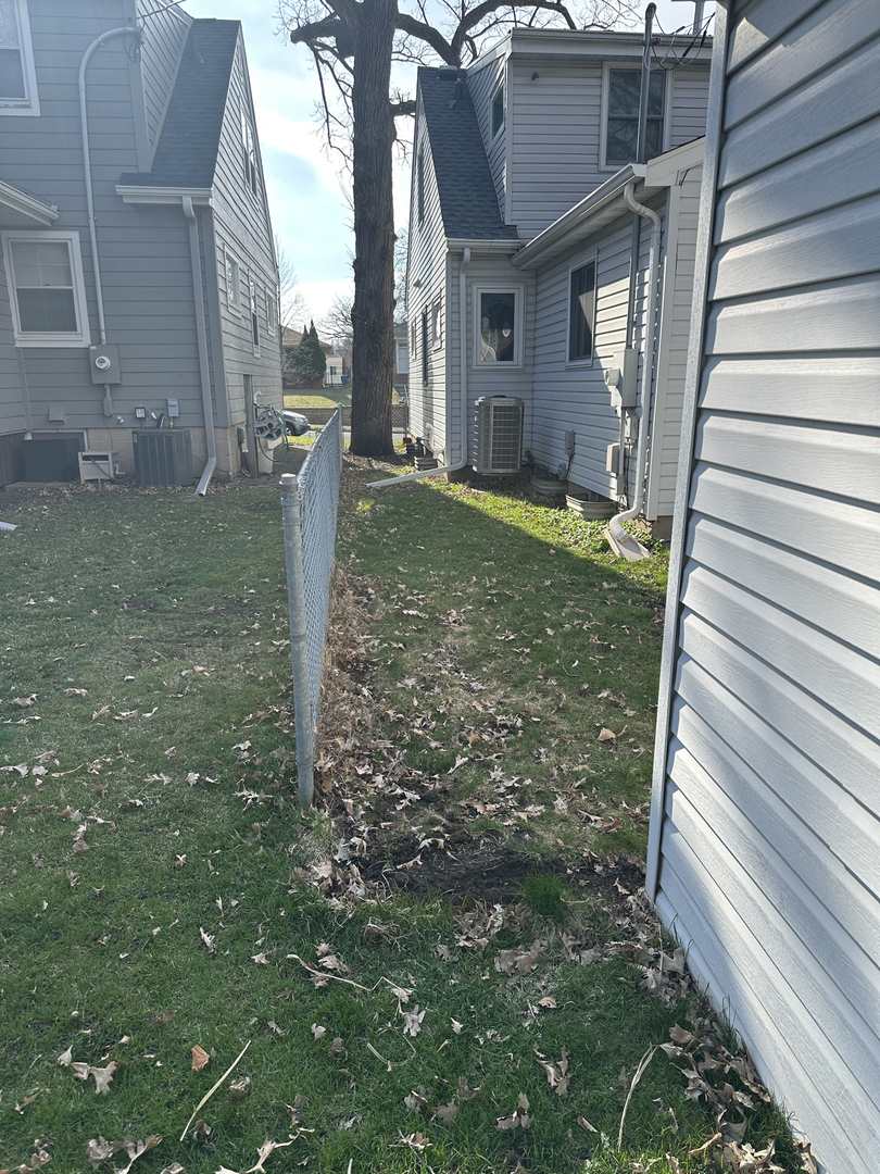 Fence line between two houses after posts were pulled
